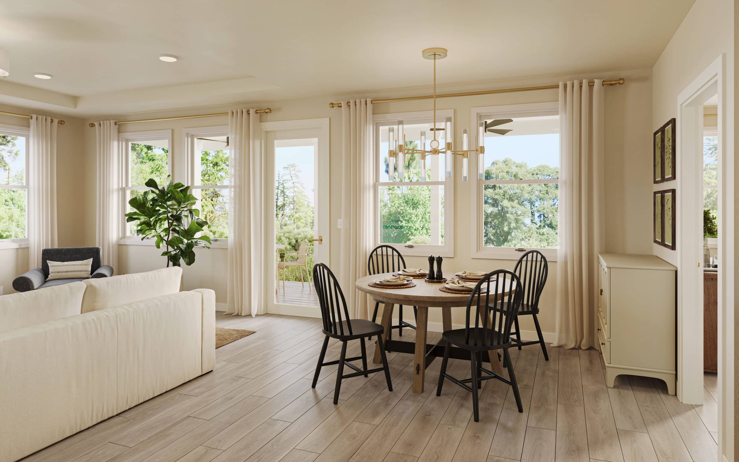Bright open-plan living and dining room with a round table, black chairs, white sofas, large windows, and a chandelier