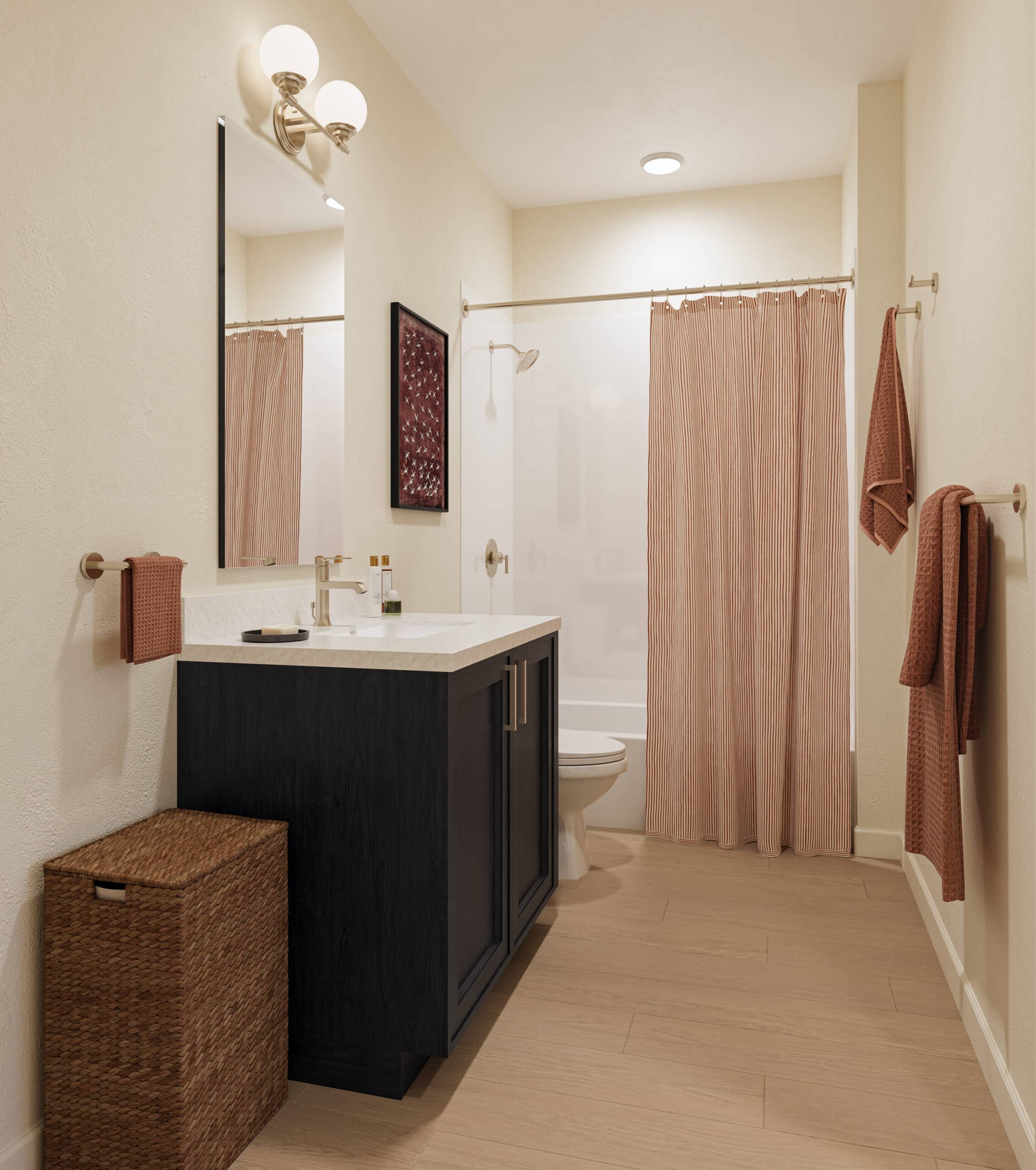Bright bathroom with a black vanity, large mirror, striped shower curtain, towels, and woven storage baskets