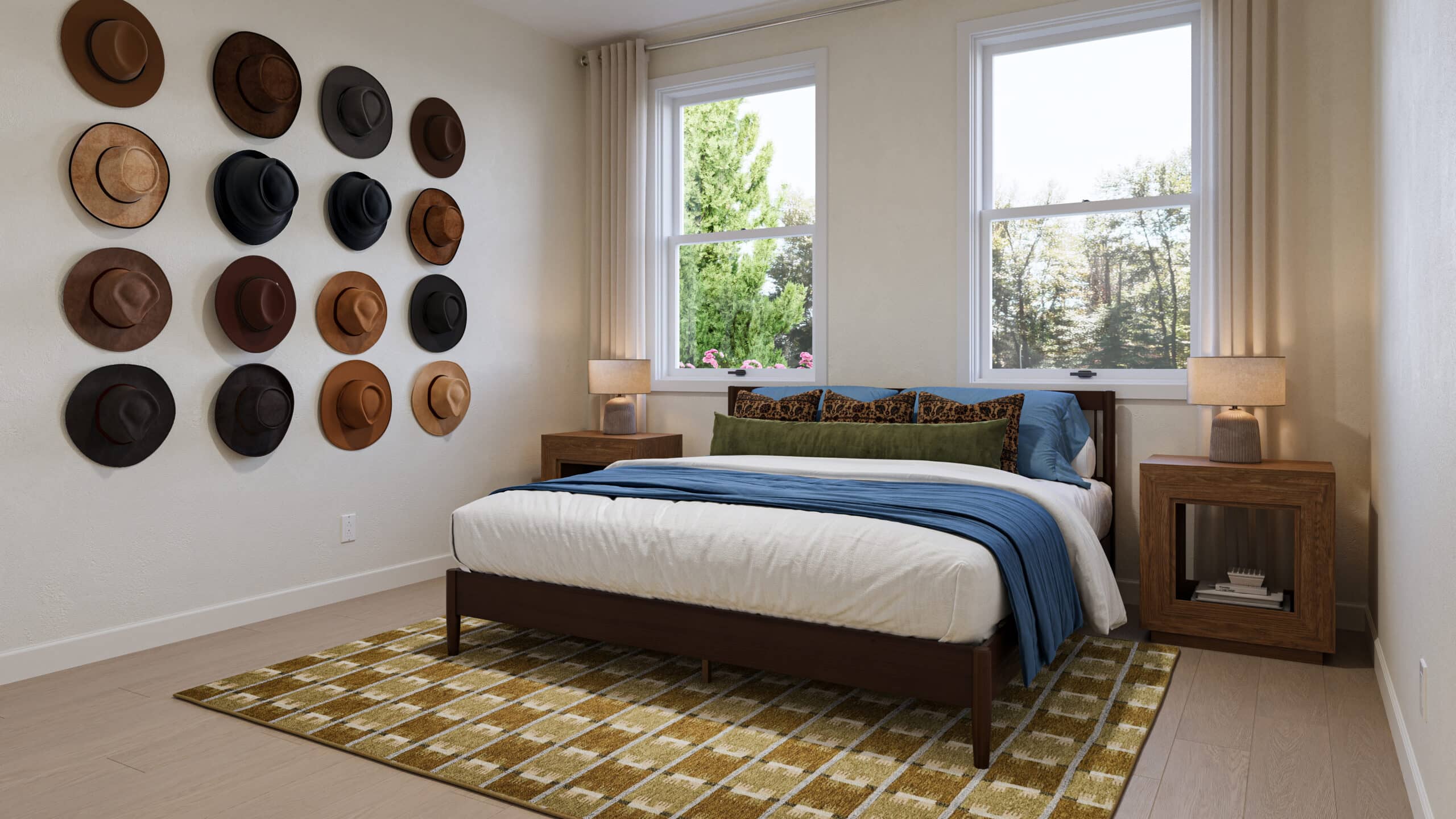 Bedroom with a neatly made bed, bedside tables and lamps, windows overlooking trees, and hats displayed on the wall