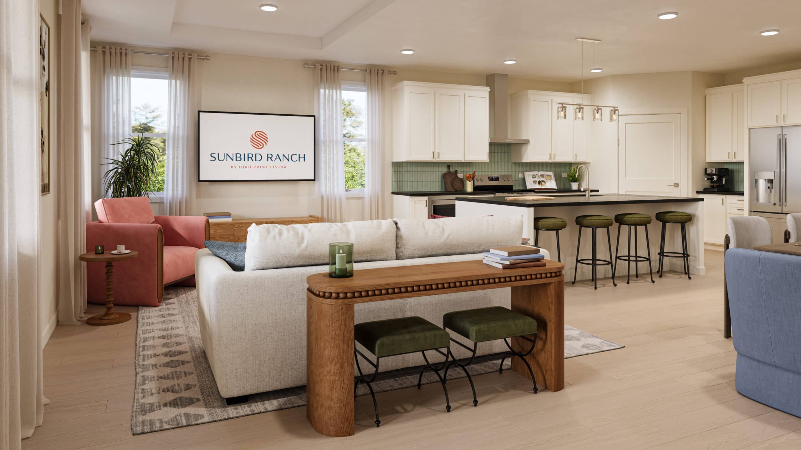 Open-plan living room and kitchen with white cabinetry, central island, furnishings, and a screen reading “Sunbird Ranch.”